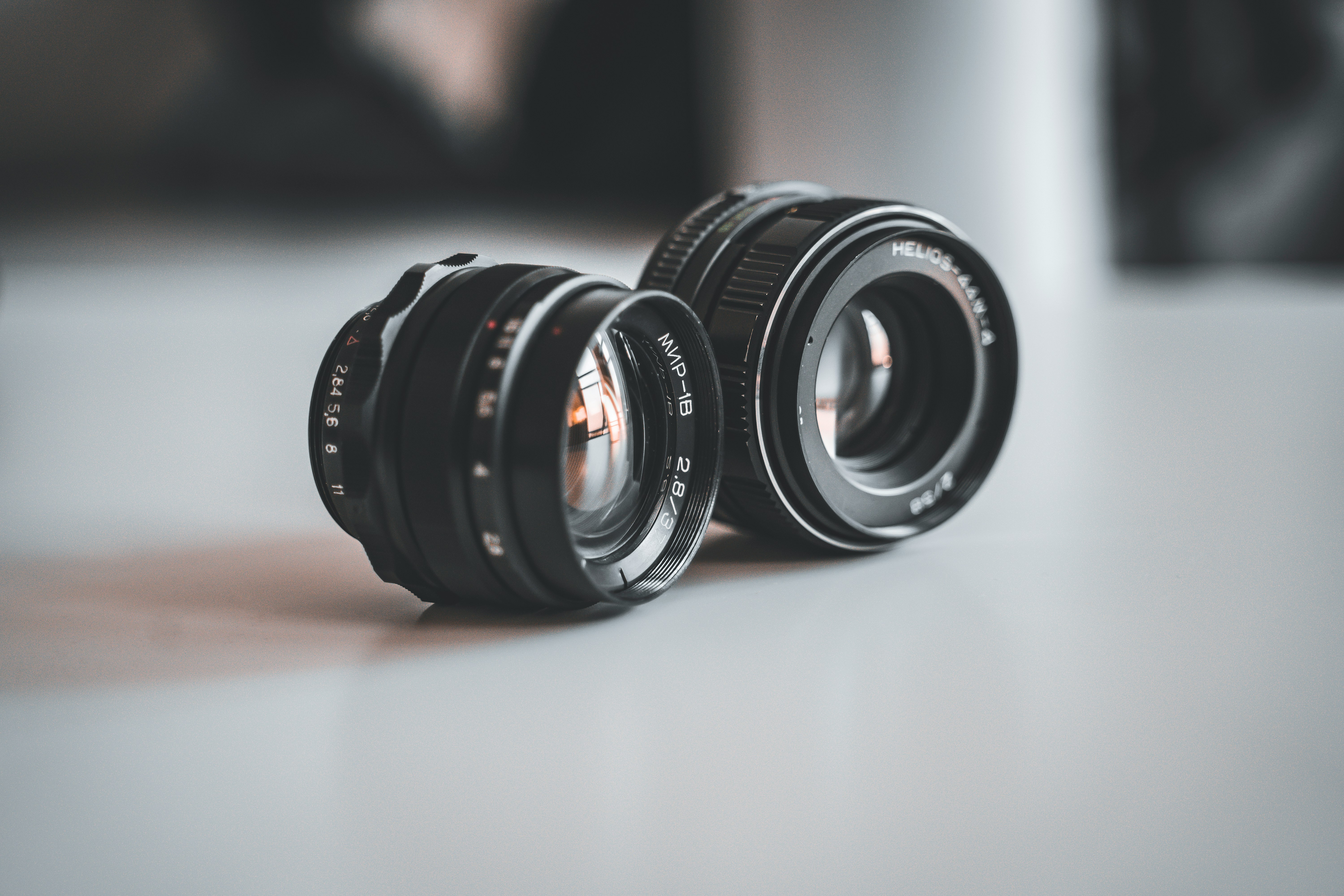 black camera lens on white table